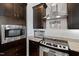 Close up of the kitchen with stainless steel appliances and dark wood cabinets at 400 W North St # 1204, Raleigh, NC 27603