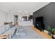 Open-concept living room with kitchen and dining area, hardwood floors, and modern decor at 400 W North St # 1204, Raleigh, NC 27603
