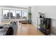 Living room featuring hardwood floors, large windows with city views, and modern decor at 400 W North St # 1204, Raleigh, NC 27603