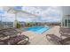 Rooftop pool deck featuring lounge chairs, a pergola, and city views at 400 W North St # 1204, Raleigh, NC 27603