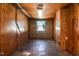 The wood paneled basement includes a window with curtains and a fluorescent light fixture at 408 Rand Rd, Raleigh, NC 27603