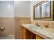 Small bathroom with a sink, cabinet, and mirror with gold accents at 408 Rand Rd, Raleigh, NC 27603