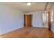 This is a bedroom featuring wood floors and a hallway to an adjacent bathroom at 408 Rand Rd, Raleigh, NC 27603