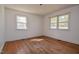 This bedroom has two windows allowing for natural light and features wood flooring at 408 Rand Rd, Raleigh, NC 27603
