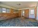Bonus room with patterned carpet, brick walls, and access to a laundry room at 408 Rand Rd, Raleigh, NC 27603
