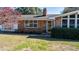 Charming brick home featuring well-maintained landscaping and a welcoming entrance at 408 Rand Rd, Raleigh, NC 27603