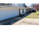 Exterior showcasing a brick home, attached garage, and well-maintained landscaping at 408 Rand Rd, Raleigh, NC 27603