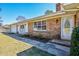 Charming single-story home with brick facade, white trim, and landscaped front yard at 408 Rand Rd, Raleigh, NC 27603