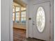 Elegant front door with decorative glass, leading to a sunlit interior with hardwood floors at 408 Rand Rd, Raleigh, NC 27603