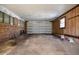 Spacious garage with a roll up door, brick walls, and windows for natural light at 408 Rand Rd, Raleigh, NC 27603