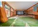 This oversized garage has a back door, a roll up door, shelving and brick elements at 408 Rand Rd, Raleigh, NC 27603