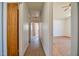 Hallway with wooden floors and white walls leading to multiple rooms at 408 Rand Rd, Raleigh, NC 27603