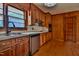 The kitchen has wood cabinets, stainless steel appliances and wood paneling at 408 Rand Rd, Raleigh, NC 27603