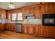 A kitchen features wooden cabinets, stainless steel dishwasher, range hood and oven at 408 Rand Rd, Raleigh, NC 27603