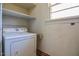 A laundry room features a dryer, a small window and shelving at 408 Rand Rd, Raleigh, NC 27603
