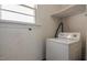 A laundry room featuring a washing machine and minimal shelving at 408 Rand Rd, Raleigh, NC 27603