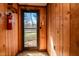 Wood-paneled mud room featuring a window and a door to the exterior of the house at 408 Rand Rd, Raleigh, NC 27603