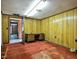 Office space featuring wood paneling, carpet, and a built-in desk with storage at 408 Rand Rd, Raleigh, NC 27603