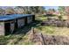 Outdoor shed in backyard of property has an open door and dead vines at 408 Rand Rd, Raleigh, NC 27603