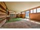 Large sunroom with brick walls, wood paneling, and views of the property's exterior at 408 Rand Rd, Raleigh, NC 27603
