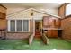 Bright sunroom featuring a brick accent wall, cabinets, and an indoor/outdoor carpet at 408 Rand Rd, Raleigh, NC 27603