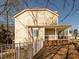 Side view of a backyard featuring a cozy, covered porch with seating area, ideal for relaxing and enjoying outdoor space at 424 Hocutt Farm Dr, Clayton, NC 27527