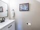 Stylish half bathroom features a marble countertop, modern fixtures, and decorative art at 424 Hocutt Farm Dr, Clayton, NC 27527