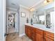 A bathroom with a double vanity, ceramic tile flooring, and separate tub and shower at 424 Hocutt Farm Dr, Clayton, NC 27527