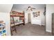 A bedroom with a bunk bed, ceiling fan, neutral walls, and a doorway to the hallway at 424 Hocutt Farm Dr, Clayton, NC 27527