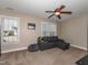 Well-lit bedroom features a neutral color palette, a ceiling fan, and a comfortable seating area at 424 Hocutt Farm Dr, Clayton, NC 27527