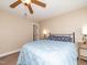 A bedroom with a ceiling fan, blue duvet, and a doorway to the hallway at 424 Hocutt Farm Dr, Clayton, NC 27527