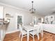 Charming dining area with white table/chairs with backyard access and living space access at 424 Hocutt Farm Dr, Clayton, NC 27527