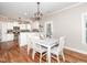 Charming dining area with white table/chairs with backyard access and kitchen access at 424 Hocutt Farm Dr, Clayton, NC 27527