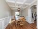 Formal dining room with coffered ceilings, hardwood floors, and a large dining table at 424 Hocutt Farm Dr, Clayton, NC 27527