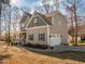 Two-story home with a front porch and a side-entry garage on a well-manicured lawn at 424 Hocutt Farm Dr, Clayton, NC 27527