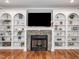 Elegant fireplace featuring stone surround, built-in shelves, and modern decor at 424 Hocutt Farm Dr, Clayton, NC 27527