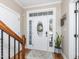 Elegant foyer featuring a decorative front door, hardwood floors, and a staircase at 424 Hocutt Farm Dr, Clayton, NC 27527