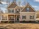 Charming two-story home featuring a welcoming front porch and a beautifully landscaped yard at 424 Hocutt Farm Dr, Clayton, NC 27527