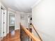 A hallway with hardwood flooring, white walls, and entryways to other rooms at 424 Hocutt Farm Dr, Clayton, NC 27527