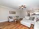Bright living room with hardwood floors, neutral furniture, and open layout to dining area at 424 Hocutt Farm Dr, Clayton, NC 27527