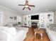 Comfortable living room features a fireplace, built-in shelving, and hardwood floors at 424 Hocutt Farm Dr, Clayton, NC 27527