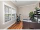 Bright home office with hardwood floors, a large window, and ample desk space for work at 424 Hocutt Farm Dr, Clayton, NC 27527