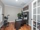 Well-lit home office featuring hardwood floors, built-in storage, and a view of the outdoors at 424 Hocutt Farm Dr, Clayton, NC 27527