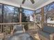 Cozy screened porch featuring comfortable seating with views of the backyard and surrounding nature at 424 Hocutt Farm Dr, Clayton, NC 27527