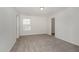 Bright bedroom featuring neutral carpet, freshly painted walls, and a walk-in closet at 4320 Stony Falls Way, Knightdale, NC 27545