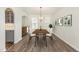 Stylish dining room with wood table, artwork, and a view to the kitchen at 4320 Stony Falls Way, Knightdale, NC 27545
