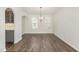 Open dining area with modern chandelier and views to the kitchen at 4320 Stony Falls Way, Knightdale, NC 27545