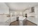 Bright kitchen featuring white cabinets, stainless steel appliances, a central island, and hardwood flooring at 4320 Stony Falls Way, Knightdale, NC 27545