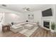 Comfortable living room with wood floors, sectional sofa, and fireplace at 4320 Stony Falls Way, Knightdale, NC 27545