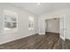 Bright living room with wood floors, white walls, and french doors at 4320 Stony Falls Way, Knightdale, NC 27545